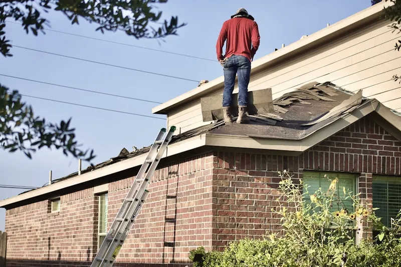 Professional roofer working on a residential roof in Amberly